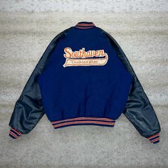 Vintage Varsity Jacket Navy Blue Orange Leather Band Southaven Chargers Made in USA Neff 90s Skate / Streetwear Great Condition: 7/10 (small marks, aka some character) Women's Size: Large Pit to Pit: 24" Length: 24.5"  Sleeve Length: 21" 90s Style Fall Outerwear For Streetwear, Retro Blue Outerwear With Letter Print, Retro Varsity Jacket With Pockets For Streetwear, Vintage College Outerwear With Letter Print, Navy Letter Print Outerwear For Fall, 90s Style Varsity Jacket For Winter Streetwear, 90s Style Winter Varsity Jacket For Streetwear, Navy Letter Print Streetwear Outerwear, Navy Letter Print Outerwear For Streetwear