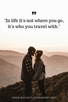 two people standing on top of a mountain with a quote above them that says, in life it's not where you go, it's who you travel with