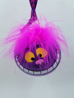 a close up of a purple object with pink hair