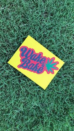 a sticker that is laying in the grass on top of a patch of grass