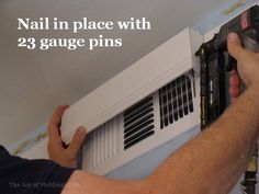 a man is working on an air conditioner with the words nail in place with 23 gauge pins