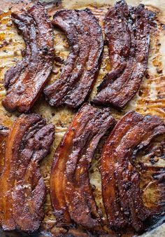 sliced bacon on a baking sheet ready to be cooked in the oven for barbecues