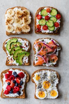 four slices of bread with different types of food on top of each other, including fruits and vegetables