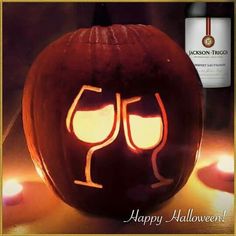 a pumpkin with two wine glasses carved into it's face and the words happy halloween