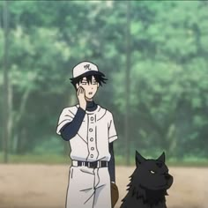 a baseball player standing next to a black dog in front of some trees and grass