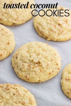 several cookies on a baking sheet with the words toasted coconut cookies