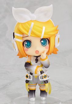 a figurine is shown with blue eyes and blonde hair, wearing headphones