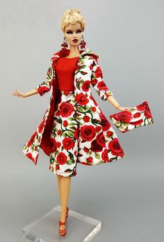 a barbie doll wearing a red and white dress with roses on it's sleeves