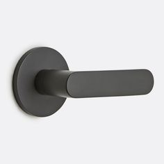 an image of the handle on a wall mounted toilet paper dispenser in matte black