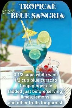 a tropical blue sangria cocktail with limes and cherries