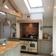 a kitchen with an oven, stove and counter top in the middle of the room