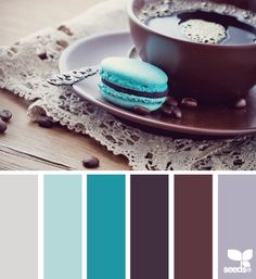 a cup of coffee and some macaroons on a plate with the color scheme