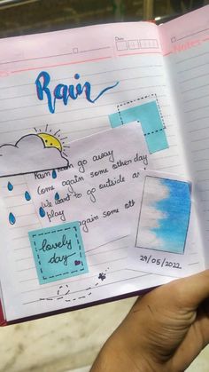 someone is holding up a notebook with rain written on it and the pages are lined in different colors