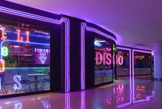 an empty room with neon signs on the walls