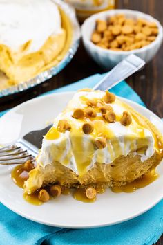 a piece of pie on a white plate with a fork in front of the pie