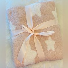 a pink and white blanket with a bow on it