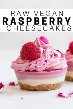 raw vegan raspberry cheesecakes are topped with whipped cream and fresh raspberries