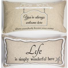 two pillows with words on them sitting next to each other