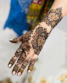 a woman's hand with hennap on it and her hands in the background