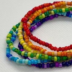 Celebrate living authentically with a Pride bracelet stack! Gender inclusive and perfect for yourself or gifting to friends, romantic partner, or expressing support for someone who's recently coming out. It's also a unique set of colorful bracelets for anyone else who digs rainbows. Switch it up by rearranging the colors, or add them to some of your faves to get a new twist on your accessorizing.   This set has six individual stretch bracelets, each in shades of red, orange, yellow, green, blue, and violet glass seed beads. As a handmade item, each set will vary slightly due to randomization of patterns.  Giving as a gift? The 7" size is considered "standard" and fits a lot of teens and adults. Treating yourself? Measure your wrist to choose your desired size. Selecting a set that's a litt Tiny Beads Wrap Bracelet As Gift, Wrap Bracelet With Tiny Round Beads As Gift, Wrap Bracelet With Round Beads As Gift, Rainbow Tiny Beads Friendship Bracelets, Rainbow Beaded Bracelets With Spacer Beads For Friendship, Everyday Rainbow Beaded Bracelets With Tiny Beads, Rainbow Tiny Beads Bracelet For Gift, Gift Beaded Heishi Beads Wrap Bracelet, Beaded Heishi Beads Wrap Bracelet As Gift