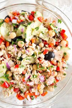 a salad in a glass bowl on top of a table