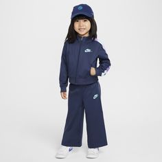 Put your little athlete in this performance tracksuit, made of soft pique knit fabric enhanced with quick-drying, moisture-wicking Dri-FIT technology to help keep them cool and dry while they play. The jacket has a full-zip closure and a roomy cut that make layering easy, and pockets at the sides come in handy for stashing small items. The matching pants have a stretch waistband that provides a comfy fit. Pair with any Nike tank or tee for a completed look. Blue Moisture-wicking Tracksuit For Sports, Blue Tracksuit For Training, Blue Tracksuit For Training, Sportswear Style, Blue Tracksuit For Sports, Blue Sportswear Tracksuit For Training, Blue Sportswear Tracksuit For Sports, Blue Casual Tracksuit For Training, Functional Moisture-wicking Tracksuit For Training, Navy Sporty Long Sleeve Tracksuit