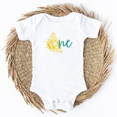 Introducing the Bee Day ONE Baby Birthday Bodysuit, a delightful and adorable outfit designed to make your little one's first birthday extra special. Crafted with love, this bodysuit captures the joy and sweetness of your baby's milestone celebration. Made from soft, breathable cotton fabric, the Bee Day ONE bodysuit ensures utmost comfort for your precious one. Its gentle and stretchy material is perfect for your baby's delicate skin, allowing them to move and play freely throughout the day. Th Playful Short Sleeve Bodysuit For First Birthday, Summer Birthday Onesie With Short Sleeves, First Birthday Spring Cotton Bodysuit, Spring Cotton Bodysuit For First Birthday, Fitted Onesie For First Birthday, First Birthday Spring Onesie With Short Sleeves, Family Matching Summer Birthday Onesie, Summer Family Matching Birthday Onesie, Family Matching Onesie For Birthday In Summer