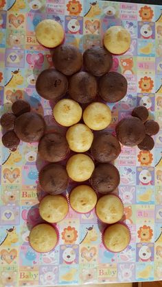 some cupcakes and muffins are arranged in the shape of a bear