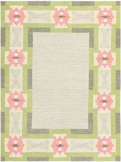 an area rug with pink and green flowers on it