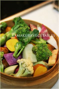 a wooden bowl filled with assorted vegetables