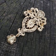 An elegant drop brooch or flat back embellishment in gold tone alloy metal. This is studded with clear crystal rhinestones and glass focal stones. Jointed in two places, this has a bit of motion. Perfect for a flapper headband, sash, or cascading bouquet. It measures 3.75 inches (@ 9.5 cm) long by 2 inches (@ 5 cm) wide. The back is slightly concave and has spaces between the metal so it can be sewn on. It can be ordered without the pin as a flatback embellishment or with a pin to wire into broo Gold Brooch Jewelry For Wedding, Gold Wedding Brooch Jewelry, Gold Wedding Jewelry With Brooch, Gold Jeweled Brooches For Formal Occasions, Formal Gold Jeweled Brooches, Ornate Wedding Brooches With Jewels, Gold Jeweled Brooch For Formal Occasions, Gold Jeweled Brooches For Wedding, Ornate Jeweled Gold Brooches