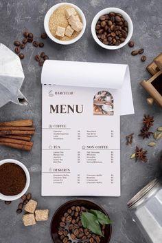 a menu with coffee beans, cinnamons and other ingredients on the table next to it