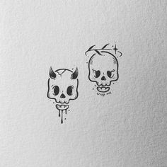 two skulls with horns on their heads are drawn in black ink, and one skull has been