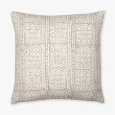 a white pillow with an intricate design on it