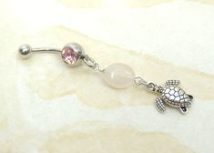 14g surgical steel belly ring features an adorable double sided sea turtle charm with natural rose quartz gemstone. You choose from prong set style barbell with pink gem or standard round barbell with pink gem. Belly ring measures 2 3/8 inches long total length. Barbell is 14g standard surgical steel. Top ball measures 5mm, bottom ball with gem measure 8mm. For Belly Button Rings: https://www.etsy.com/shop/AllAboutClass?section_id=18474235&ref=shopsection_leftnav_1 For Add a Charm Belly Ring Pink Dangle Belly Rings For Gift, Heart-shaped Pink Belly Rings For Gift, Nickel-free Dangle Belly Rings As Gift, Adjustable Nickel-free Pink Belly Rings, Adjustable Nickel-free Dangle Belly Rings, Cute Belly Rings, Belly Button Jewelry, Dangle Belly Rings, Navel Piercing