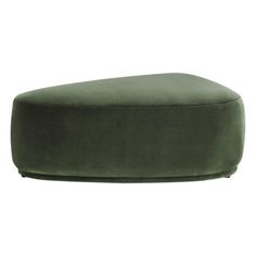 a large green ottoman sitting on top of a white floor