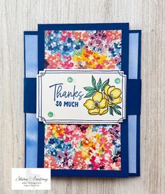 a handmade thank card with flowers on the front and blue trimmings, which reads thanks so much