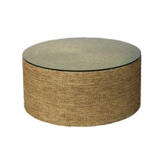 a round glass and jute coffee table on an isolated white background with no people around it