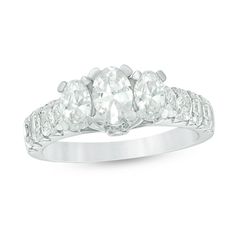 a three stone diamond ring on a white background