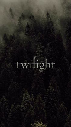 a black and white photo with the words twilight in front of some foggy trees