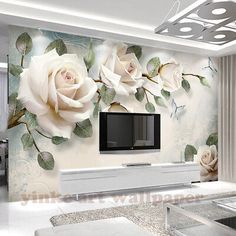 the living room is decorated with white roses and green leaves on it's wall