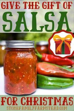 a jar filled with salsa sitting on top of a table next to peppers and peppers