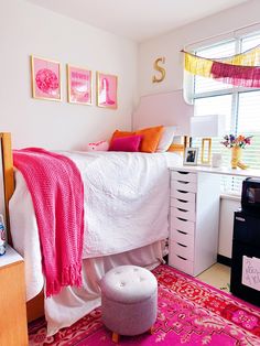 a bedroom with pink and orange decor on the walls