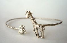 I handcrafted this bracelet using a vintage metal delicate bracelet base, a silver plated giraffe and a silver plated penguin. The parts are soldered and not glued.The bracelet is adjustable.It comes in a gift box. Extra little GIFT included separately with the packaging!More Rings selection: www.etsy.com/shop/stavri?section_id=7346628More Bracelets selection: www.etsy.com/shop/stavri?section_id=7133840More Necklaces selection: www.etsy.com/shop/stavri?section_id=6926501For more jewelry designs, Winona Meadows, Giraffe Jewelry, Penguin Jewelry, Animal Bracelet, Signature Bracelet, Favorite Animals, An Elephant, Bracelet Charm, Bracelet Bangle