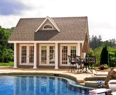 a house with a pool and patio furniture