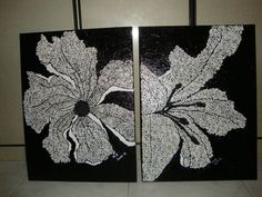 two black and white paintings with flowers on them