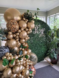 gold and green balloons are on display in the lobby