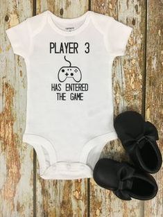 a white baby bodysuit with the words player 3 has entered the game on it