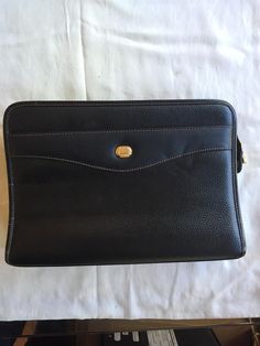 Black Dunhill leather clutch with gold-tone hardware and black lining. There is one external zipper pocket on the back and two interior zipper pockets. Dimensions = L 10.75"x D 2.5"x H 7.5".  Condition : VERY GOOD CONDITION ( 9/10 ) Fabrics : Leather  Signs of Wear:  Minor scratching on one Exterior Corner Minor nip on Exterior Trim Minor fading on Zipper-end hardware Clean and perfect inside as far as I can see Formal Leather Clutch With Zipper Closure, Classic Formal Clutch With Zipper Closure, Classic Business Clutch With Zipper Pouch, Formal Clutch With Zipper Closure, Formal Leather Clutch With Zipper Pouch, Leather Clutch With Zipper Pouch For Formal Occasions, Business Clutch With Zipper Closure, Modern Formal Clutch With Zipper Pocket, Rectangular Clutch With Zipper Pocket For Formal Events