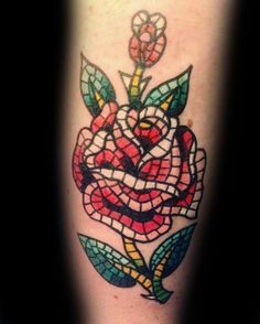 a colorful rose tattoo on the leg